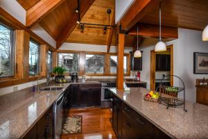 a large kitchen with wooden ceilings and wooden counters at Hawk Mountain in McHenry