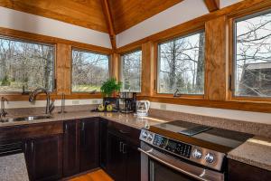 a kitchen with wooden cabinets and a sink and windows at Hawk Mountain in McHenry