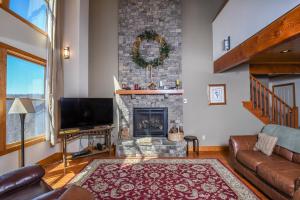 a living room with a fireplace and a television at Hawk Mountain in McHenry +91 photos