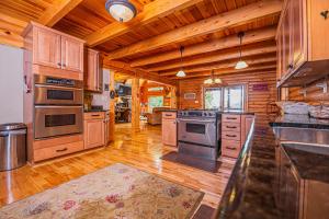 a large kitchen with wooden floors and stainless steel appliances at Altitude Adjustment in McHenry