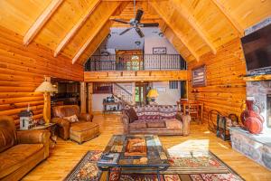a living room with leather furniture and a fireplace at Altitude Adjustment in McHenry +74 photos