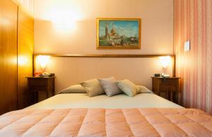 Postel nebo postele na pokoji v ubytování Holiday Rooms Antica Badia