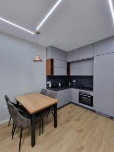 a kitchen with a table and chairs in a room at Anika Home Tirana 2 in Tirana