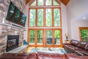 a living room with a couch and a fireplace at Lakey McLakeHouse in Swanton