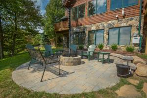 a patio with chairs and a fire pit in front of a house at Highlands Heaven in McHenry