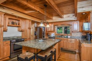 a kitchen with wooden cabinets and a large island at Highlands Heaven in McHenry +73 photos