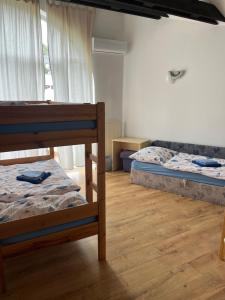 a bedroom with two bunk beds and a wooden floor at Chata TARGET Senec in Senec