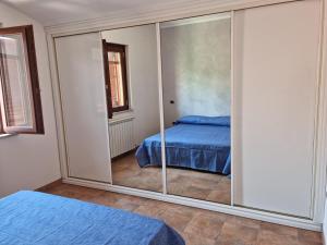 a bedroom with a large glass door with a bed at Casa vacanza Amanda in Nicotera Marina