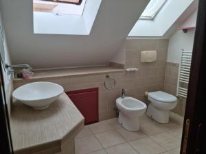 a bathroom with a sink and a toilet and a window at Casa vacanza Amanda in Nicotera Marina