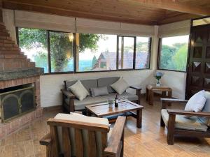 a living room with a couch and a fireplace at La Arboleda, Refugio in Cogua