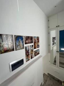 a white room with pictures on a wall at Studio El Jamil in Douar el Hafey