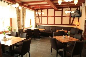 a dining room with wooden tables and chairs at Hotel Haus Burg Metternich in Beilstein