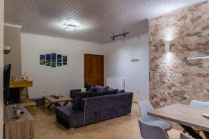 a living room with a couch and a table at G.R luxury apartment in Lefkada Town