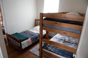two bunk beds in a small room with at Le Refuge - Gîte Familial in Saint-Angel +4 photos