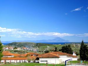 a view of a town with mountains in the background at Village view apartment in Agios Nikolaos