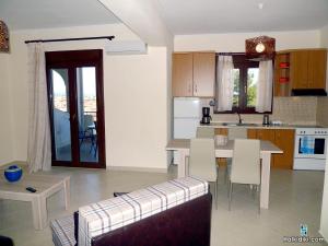 a kitchen and living room with a table and a couch at Village view apartment in Agios Nikolaos