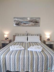 a bedroom with a bed with two towels on it at Village view apartment in Agios Nikolaos