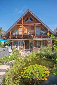 a house with a pond in front of it at B&B Stein am Rhein in Stein am Rhein