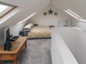 a attic bedroom with a bed and a table at True North in Scarborough