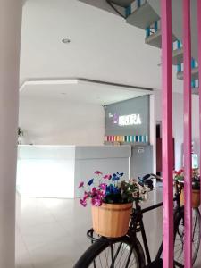 a bike with flowers in baskets in a building at The Aurora by Makati in Lembang