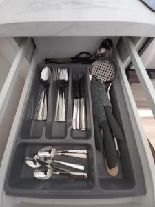 a drawer filled with utensils in a cabinet at City center apartment in Klaipėda