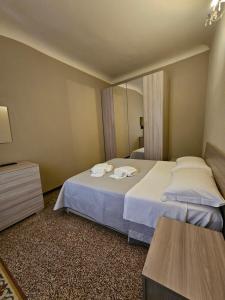 a hotel room with two beds and a mirror at White Lerici in Lerici