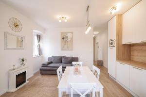 a kitchen and living room with a table and a couch at Sea Gate Apartment in Zadar