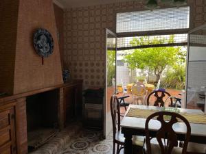 a dining room with a table and a fireplace at ROMI ORBA in Orba