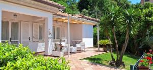 a villa with a garden and a patio at Garden Suite in Maratea