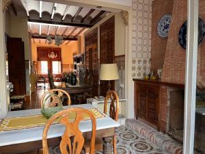 a kitchen with a table and chairs and a dining room at ROMI ORBA in Orba