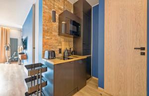 a kitchen with a sink and a counter top at Riverview Apartament Waterline SPA & Pool in Gdańsk