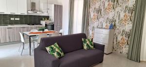 a living room with a couch and a table in a kitchen at Garden Suite in Maratea