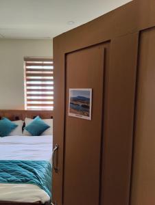 a door leading to a bedroom with two beds at Multiple Stories, Wayanad in Wayanad