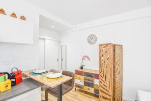 uma cozinha e sala de jantar com mesa e cadeiras em Studio neuf avec AC proche Castellane et métro em Marselha
