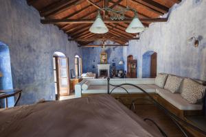 a living room with blue walls and a couch at Big Blue Pelion in Pilion