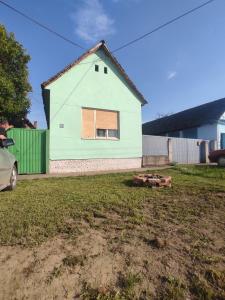a house with a green and white house at Sremac in Kupinovo
