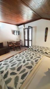 a bedroom with a bed and a dining room with a table at Vojinovic Apartments in Budva