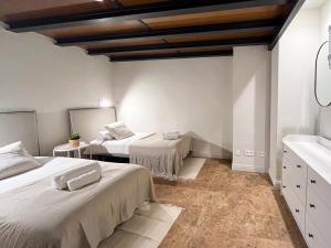 a bedroom with two beds and a sink in it at AZ Orús Factory Hotel - Parking Gratuíto in Zaragoza