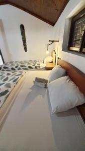 a bedroom with a bed with white pillows at Vojinovic Apartments in Budva