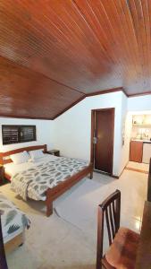 a bedroom with a bed and a wooden ceiling at Vojinovic Apartments in Budva