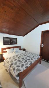 a bedroom with a large bed with a wooden ceiling at Vojinovic Apartments in Budva