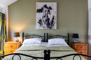 a bedroom with a bed and two night stands at The Bull at Foolow in Hucklow