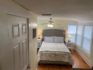 a bedroom with a bed and a ceiling fan at The Rose on Lakeside in Umatilla