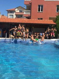 a group of people sitting in a swimming pool at Къща за гости Бор in Pomorie +4 photos