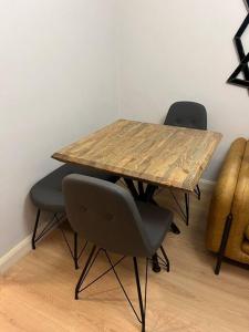 a wooden table with two chairs and a wooden table with at Cordonn residence apart city in Fethiye