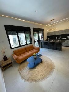 a living room with a couch and a table at Prime location apartment in TLV in Tel Aviv