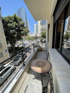 a patio with a table and chairs on a balcony at Prime location apartment in TLV in Tel Aviv