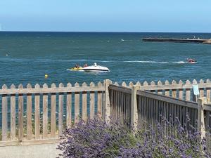a boat in the water with people in it at BRiSYL BEACH HOUSE, with amazing changing views! in Kent