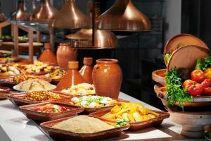 a buffet with many plates of food on a table at Iberostar Waves Founty Beach All Inclusive in Agadir