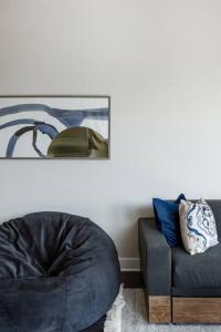 a living room with a couch and a chair at Capitol View Condos by One Fine Bnb - Paramount in Austin +22 photos